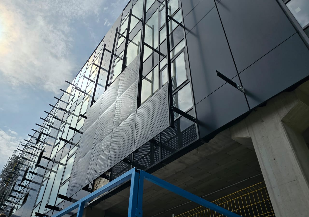 Facade panels with visible supporting brackets; manufacturing-network example